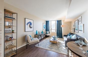 a living room with a couch and a table and a window at The Acadia at Metropolitan Park Apartments in Arlington, VA 22202