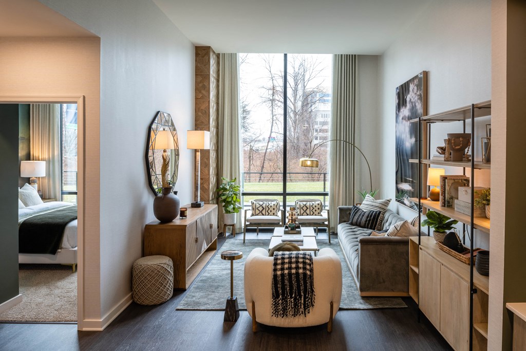 a living room filled with furniture and a large window  at Brentford at The Mile, Tysons