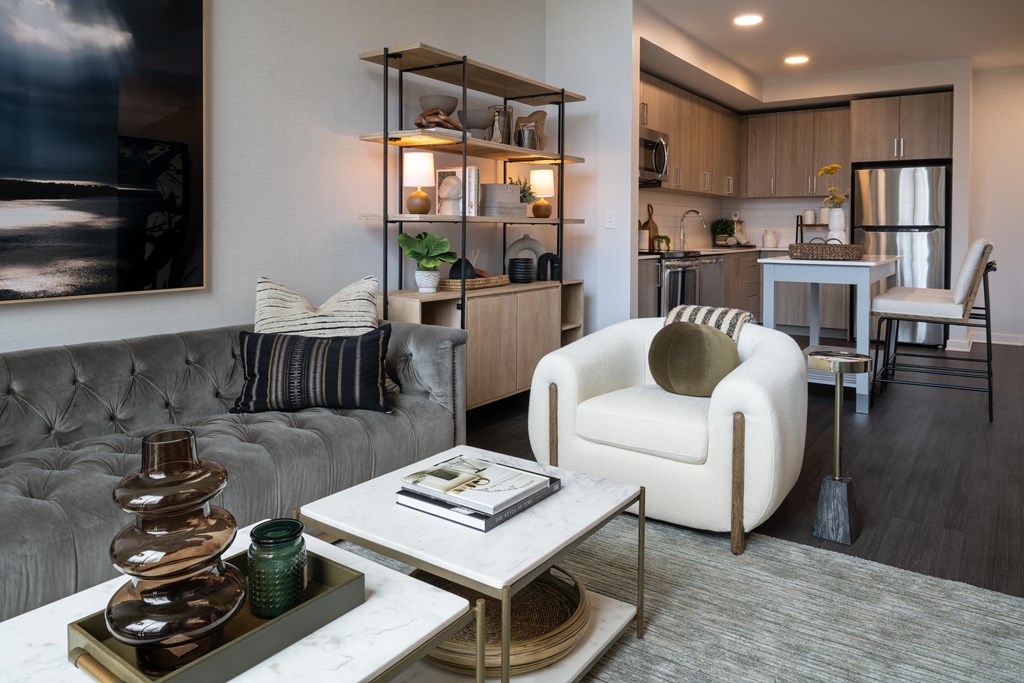 a living room filled with furniture and a large window  at Brentford at The Mile, Tysons, 22102