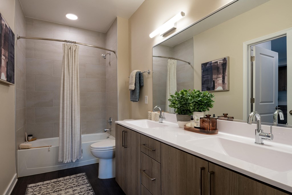 a bathroom with a shower toilet and sink  at Brentford at The Mile, Tysons, VA, 22102