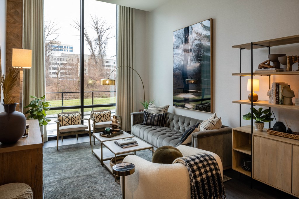 a living room filled with furniture and a large window at Brentford at The Mile, Tysons, VA, 22102