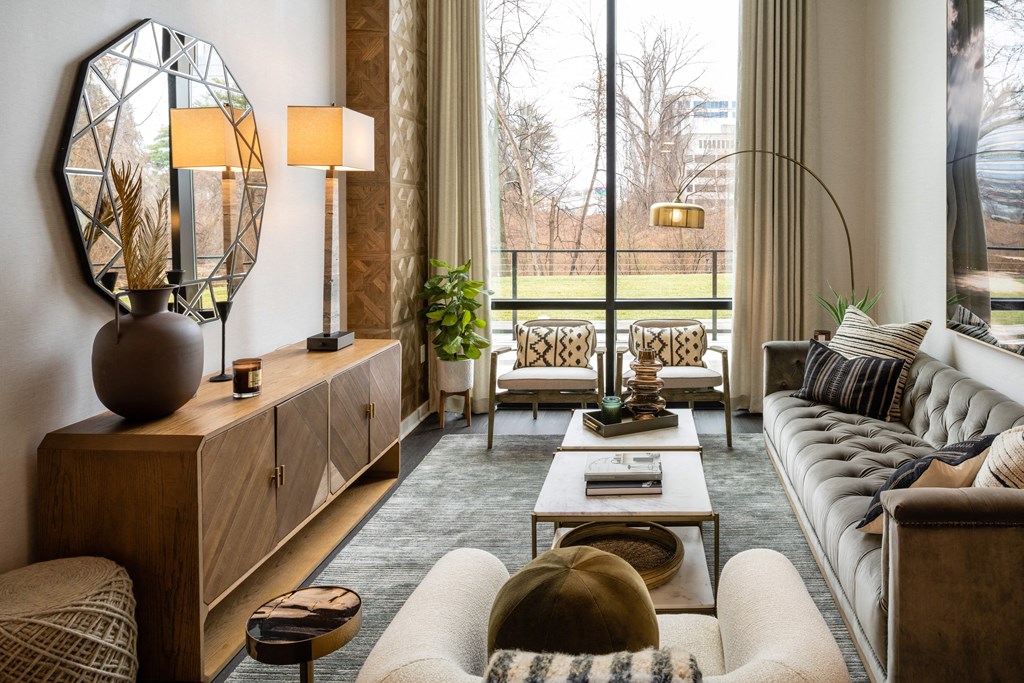 a living room filled with furniture and a large window at Brentford at The Mile, Tysons, 22102