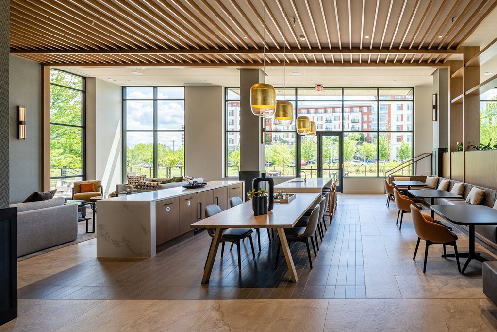 a large room with tables and chairs and large windows at Brentford at The Mile, Virginia, 22102