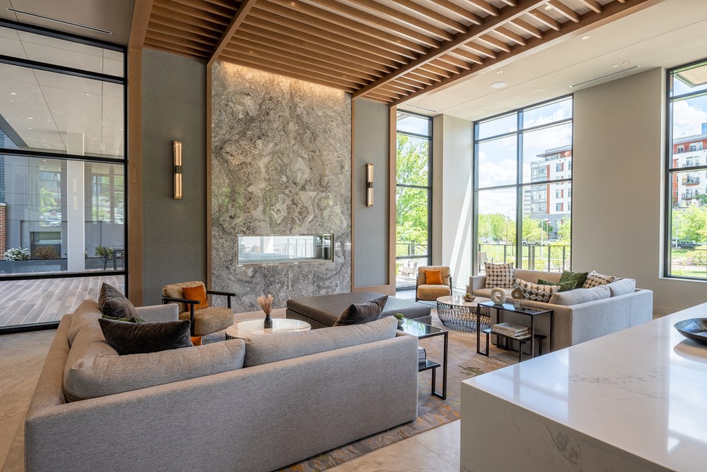 a living room filled with furniture and a large window at Brentford at The Mile, Tysons, 22102