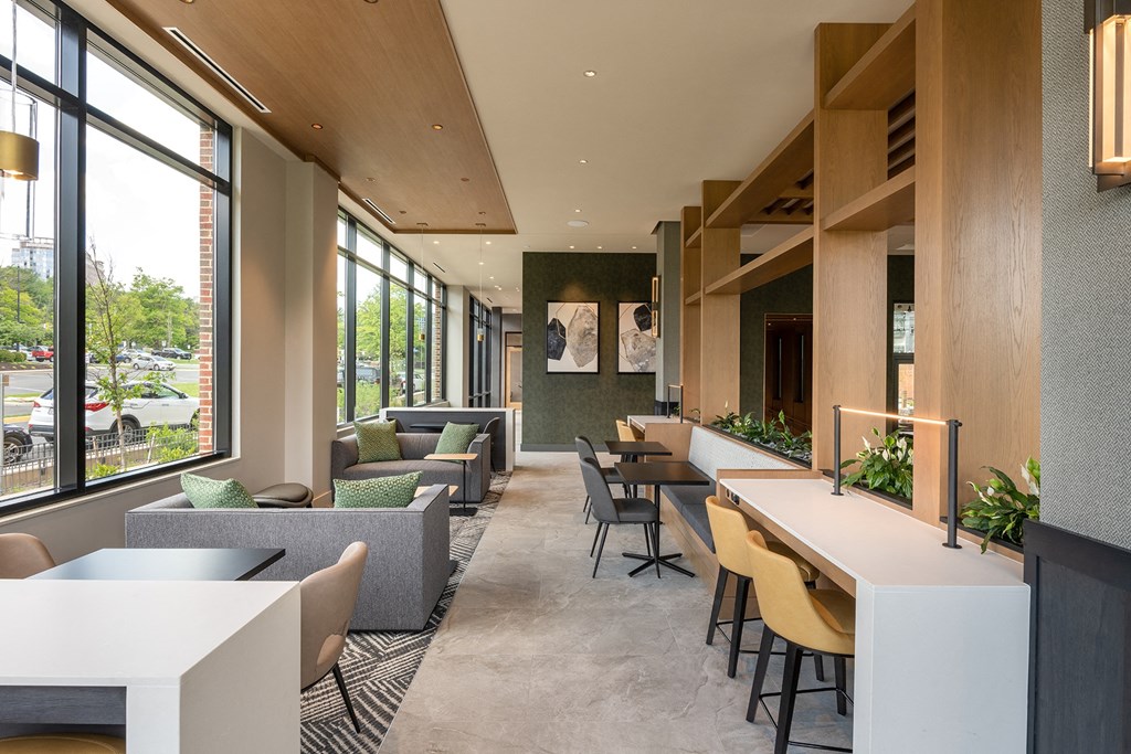 a room filled with furniture and a large window at Brentford at The Mile, Tysons, VA
