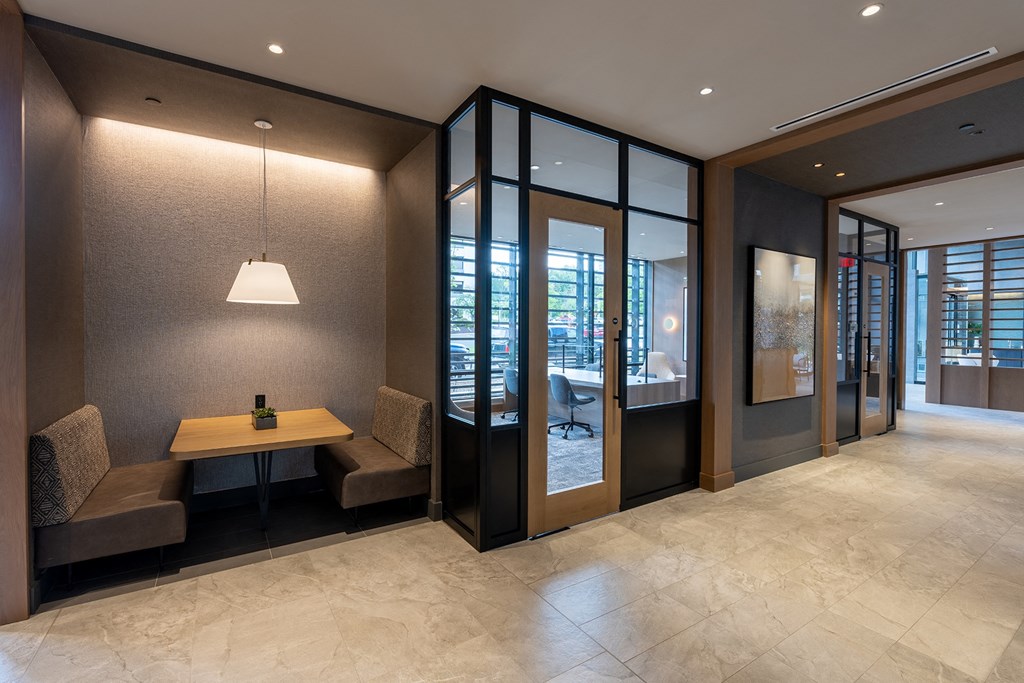 a desk and chairs in a corridor of a building at Brentford at The Mile, Virginia, 22102