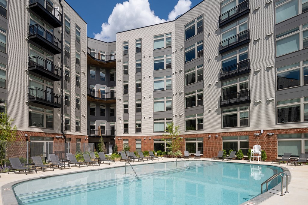 a swimming pool in front of a building at Brentford at The Mile, Tysons, VA, 22102