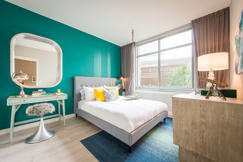 A bedroom with a bed, a desk with a chair and a lamp. at Dock 79, District of Columbia, 20003