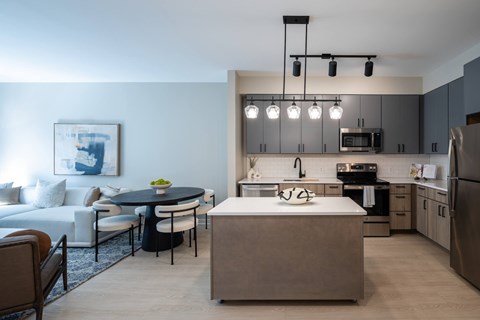 A modern kitchen with a dining table and chairs.