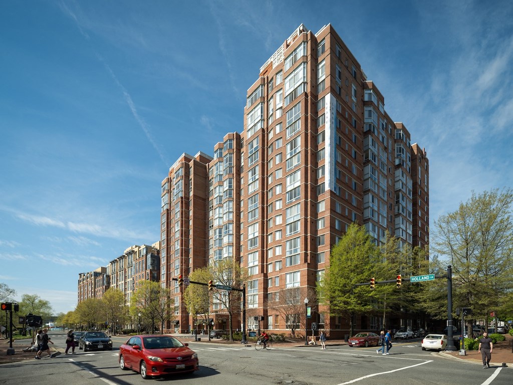 a tall building on the corner of a city street