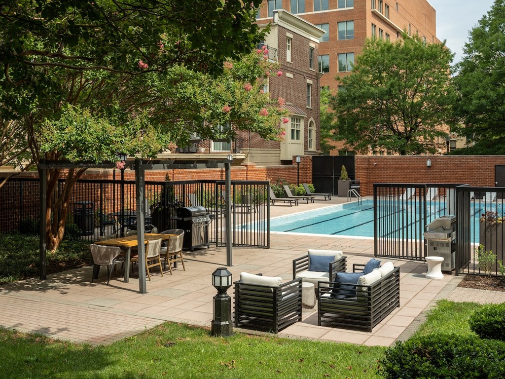 a swimming pool with chairs and tables in a courtyardat Lincoln Old Town, Alexandria, VA 22314