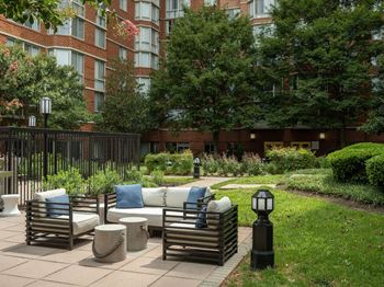a patio with a couch and chairs in a courtyard at Lincoln Old Town, Alexandria, 22314