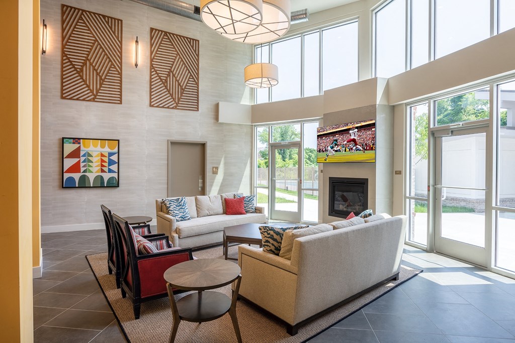 a living room filled with furniture and a large window  at Woodmore Grand, Bowie, 20721