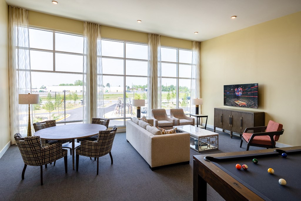 a living room with a pool table and a flat screen tv  at Woodmore Grand, Maryland, 20721