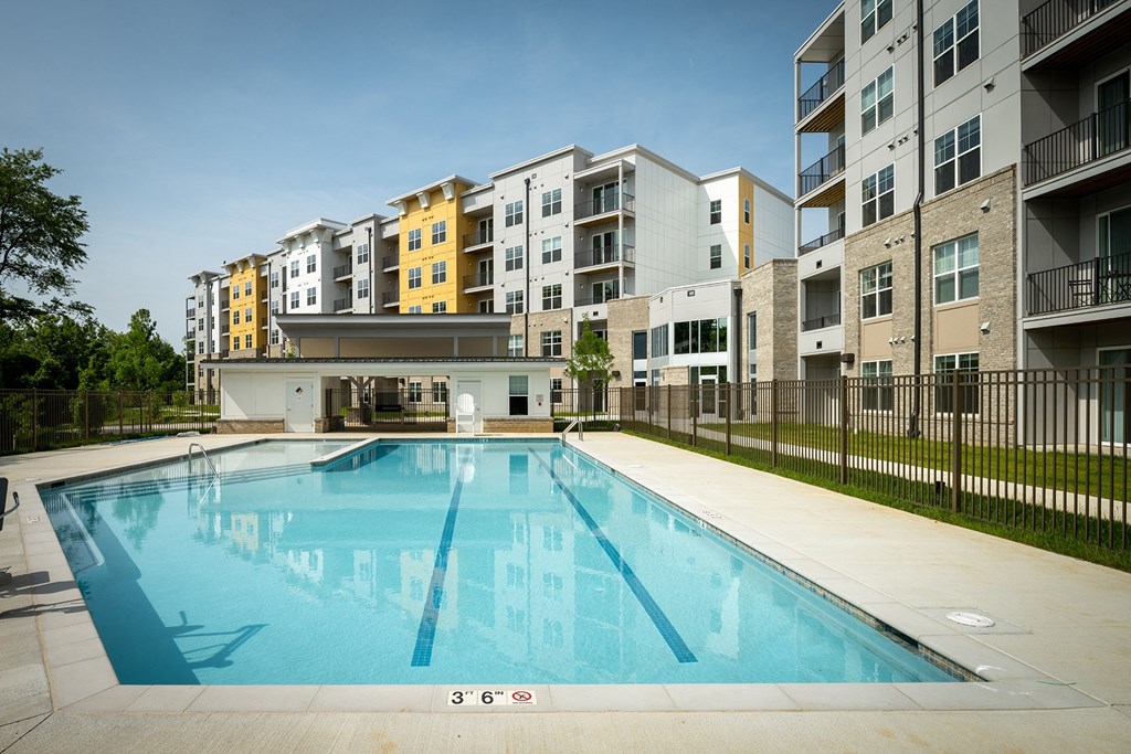 a swimming pool in front of an apartment building a swimming pool in front of an apartment building at Woodmore Grand, Maryland, 20721