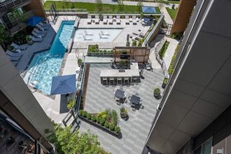 an aerial view of the pool and patio area of a hotel