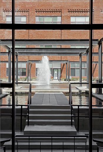 the view of the fountain through the windows of a building at Tindeco Wharf, Baltimore, MD