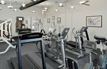 a gym with treadmills and other exercise equipment at Tindeco Wharf, Maryland