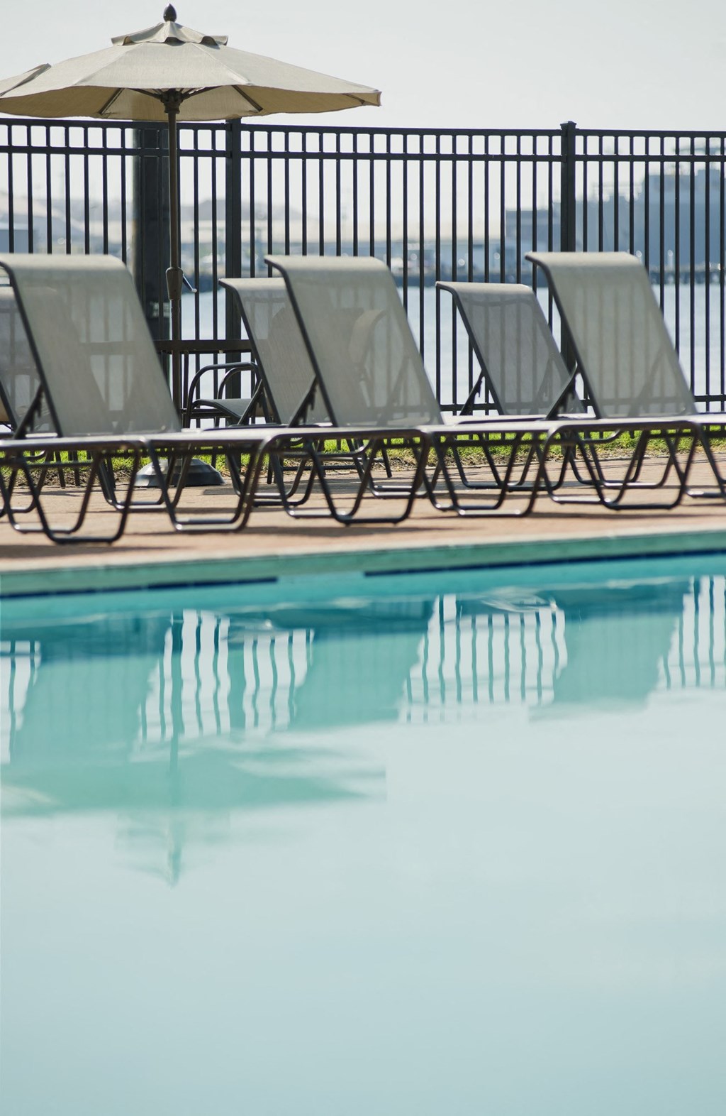 a group of lounge chairs next to a swimming pool at Tindeco Wharf, Baltimore, MD