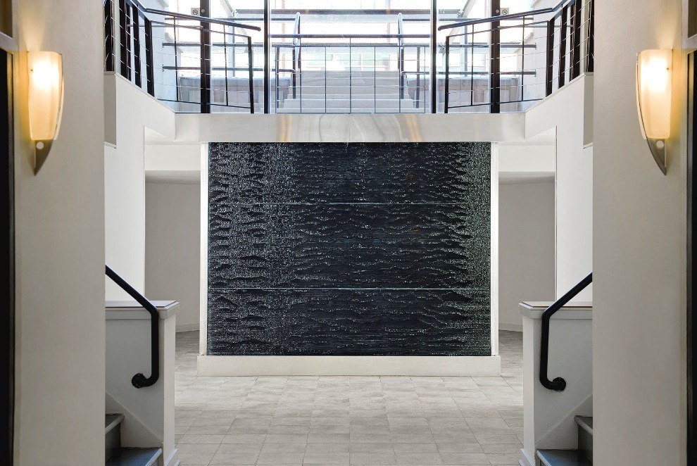 a large black water fountain in the middle of a building at Tindeco Wharf, Baltimore, MD