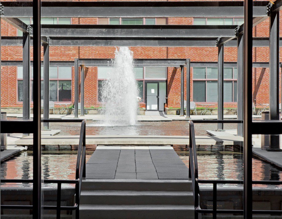a large fountain in the middle of a building at Tindeco Wharf, Baltimore, MD