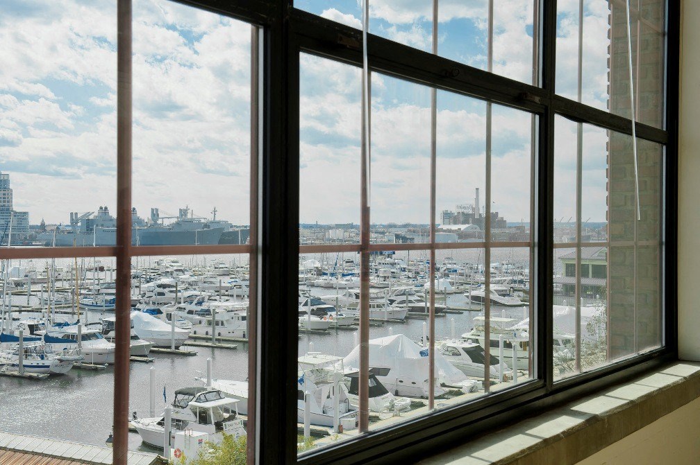 a window view of a marina filled with boats at Tindeco Wharf, Baltimore, MD 21224