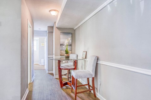 A dining room with a table and chairs.
