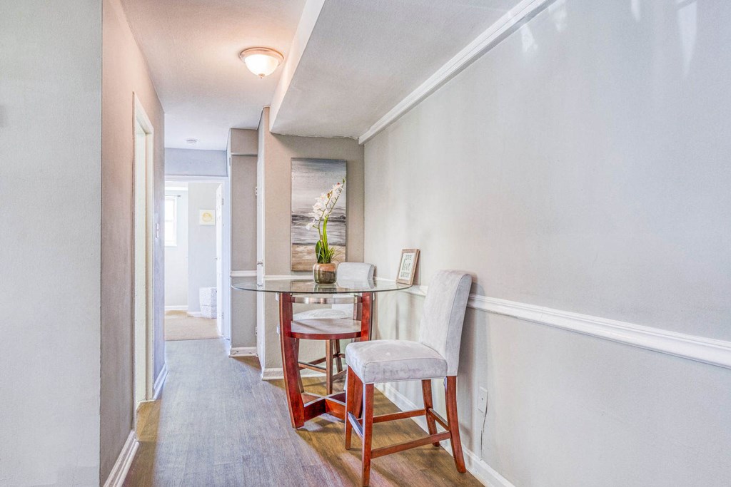 A dining room with a table and chairs. A dining room with a table and chairs at Huntwood Courts Apartments, Washington, DC