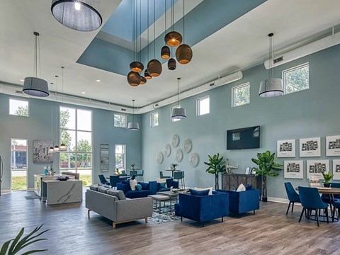 A modern living room with a blue couch and a wooden floor.