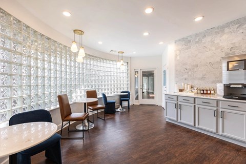 A modern kitchen with a dining table and chairs.