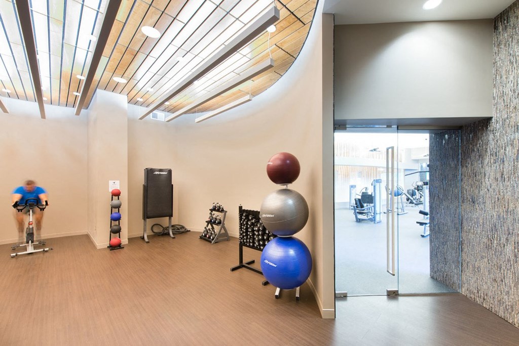 a room filled with furniture and a large window at The Acadia at Metropolitan Park, Arlington, VA