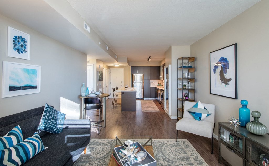 a living room with a couch a chair and a coffee table at The Acadia at Metropolitan Park, Virginia, 22202