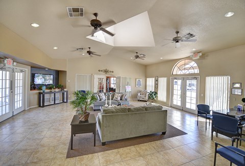 A spacious living room with a large couch and a television.