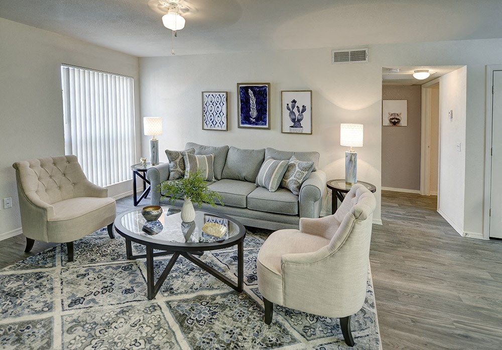 A living room with a grey couch, two chairs and a coffee table.at Cottonwood Crossing, Arizona  
