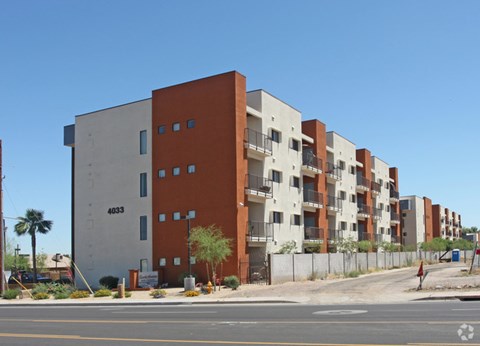 Apartment building 4033 with a palm tree in front.