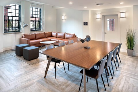 A modern living room with a wooden table and chairs.
