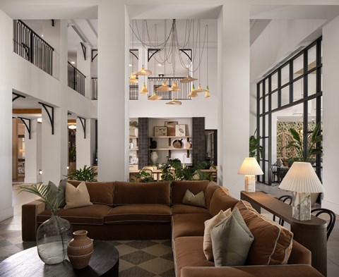 A living room with a brown couch and a coffee table.