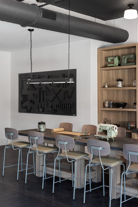 A modern kitchen with a long table and chairs.