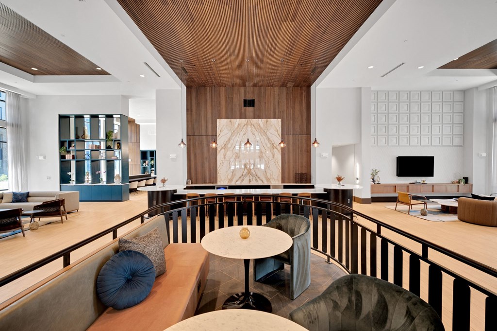 the lobby of a hotel with chairs and tables at Preston Ridge, Cary, 27513