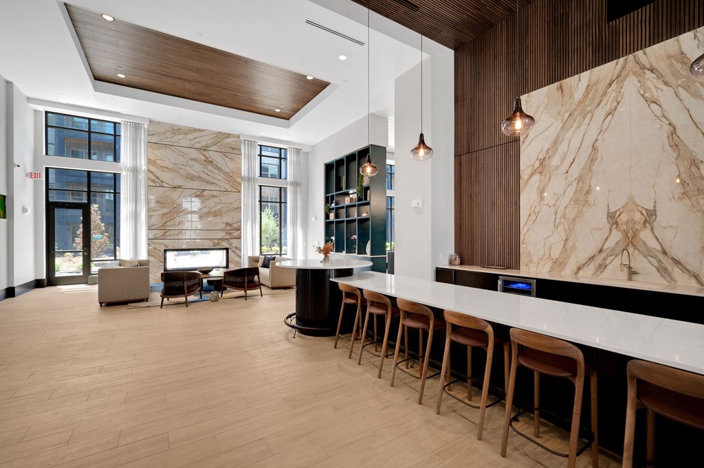 the lobby of a hotel with a bar and a marble wall at Preston Ridge, North Carolina