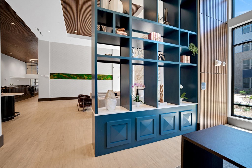 a blue bookshelf in the center of a room with a table and chairs at Preston Ridge, North Carolina, 27513