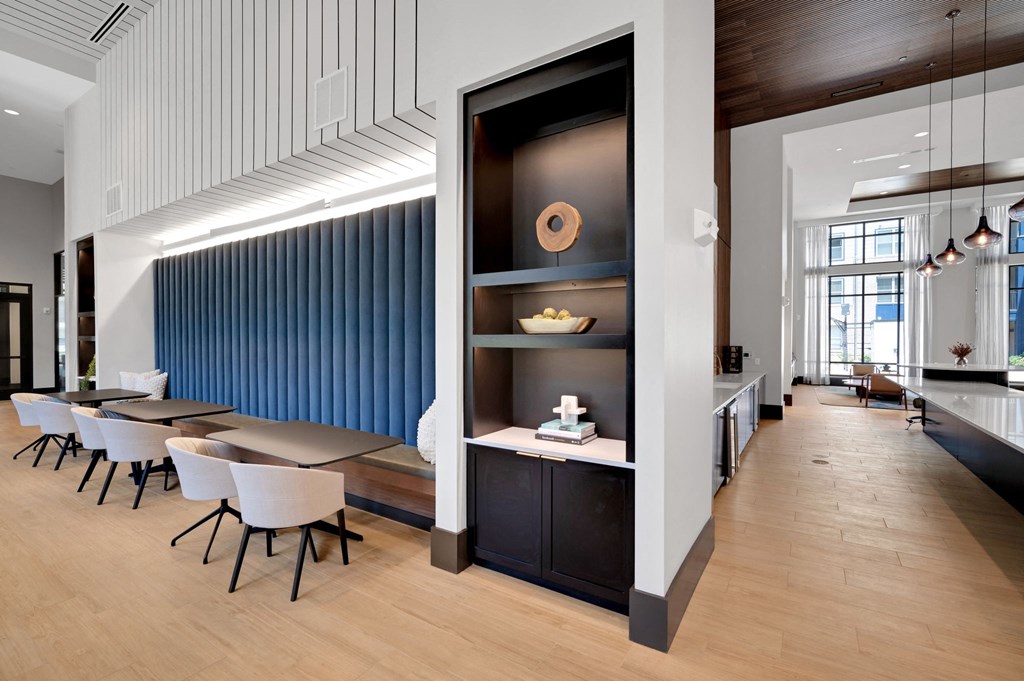 a dining room with a table and chairs and a wall with a book shelf at Preston Ridge, North Carolina