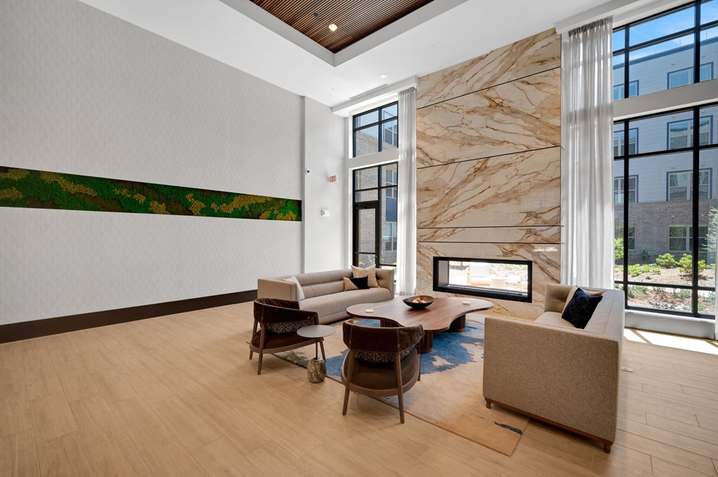 a living room with couches and chairs and a fireplace at Preston Ridge, Cary, NC