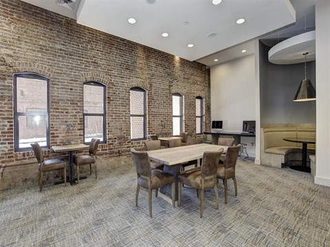 a conference room with a large table and chairs and a brick wall at The Gunther, Maryland, 21224