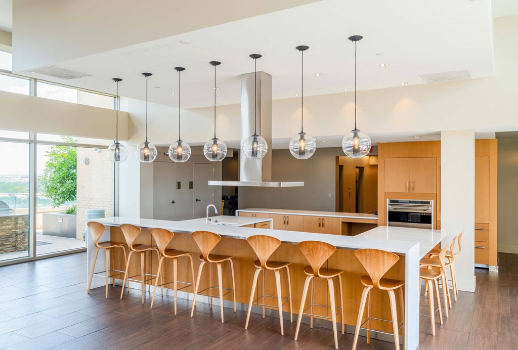 a large kitchen with an island and bar stools