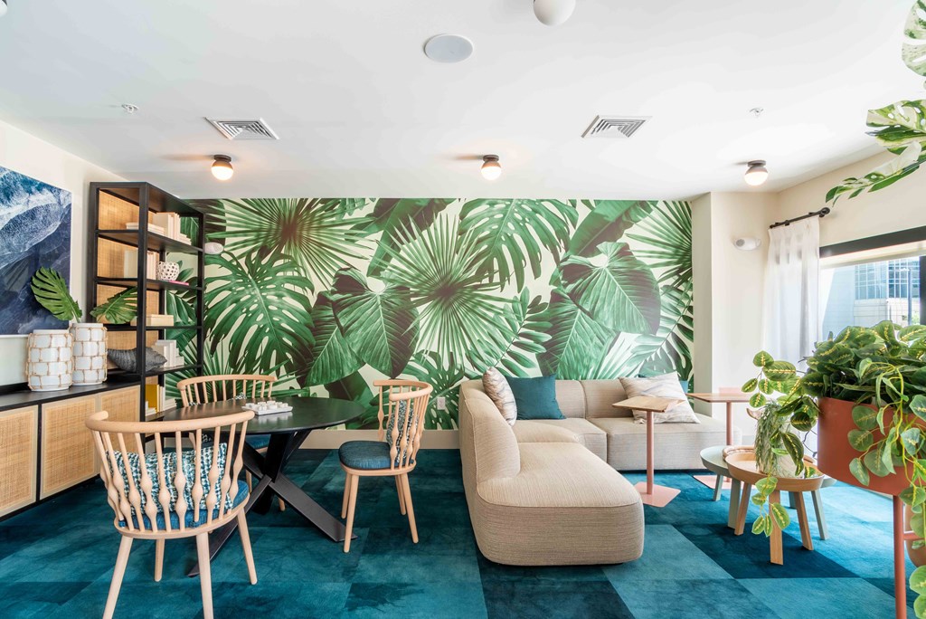 a living room with a large wall mural of plants at Metropolitan at the Riverwalk, Wilmington