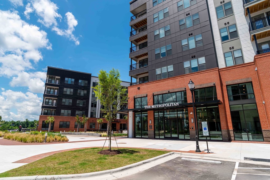an exterior view of a building with a sidewalk in front of it at the Riverwalk, Wilmington, NC 28401
