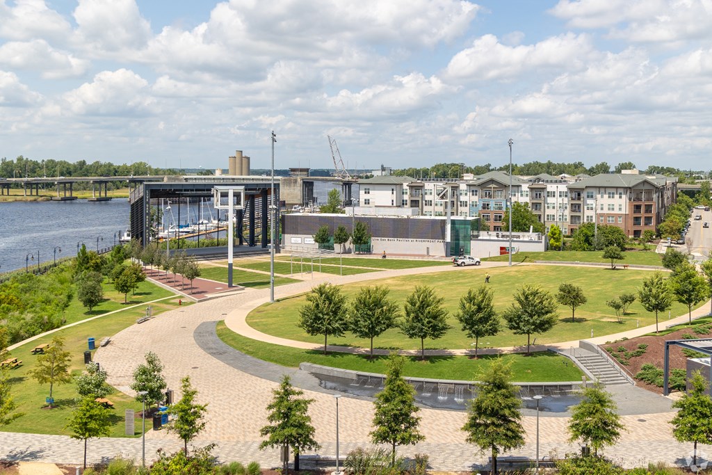 an aerial view of a park with buildings and a river at Metropolitan at the Riverwalk, Wilmington, NC 28401