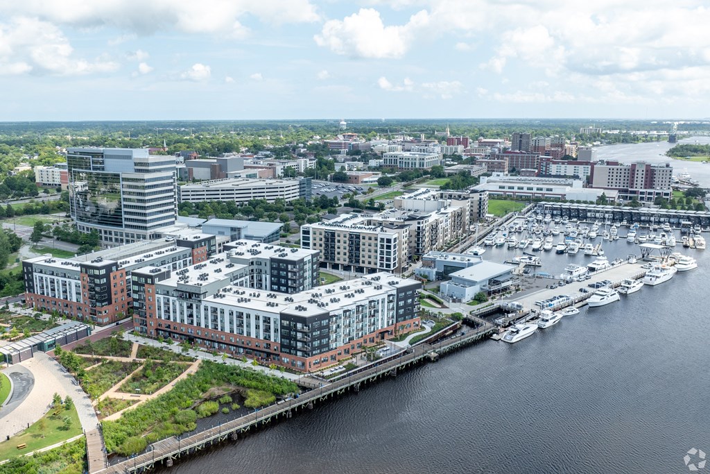 an aerial view of a city with a marina and buildings at Metropolitan at the Riverwalk, Wilmington, NC