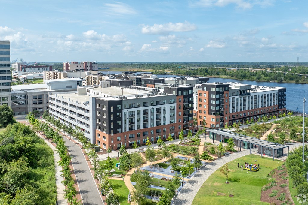 an aerial view of a city with buildings and a river at Metropolitan at the Riverwalk, Wilmington, NC, 28401